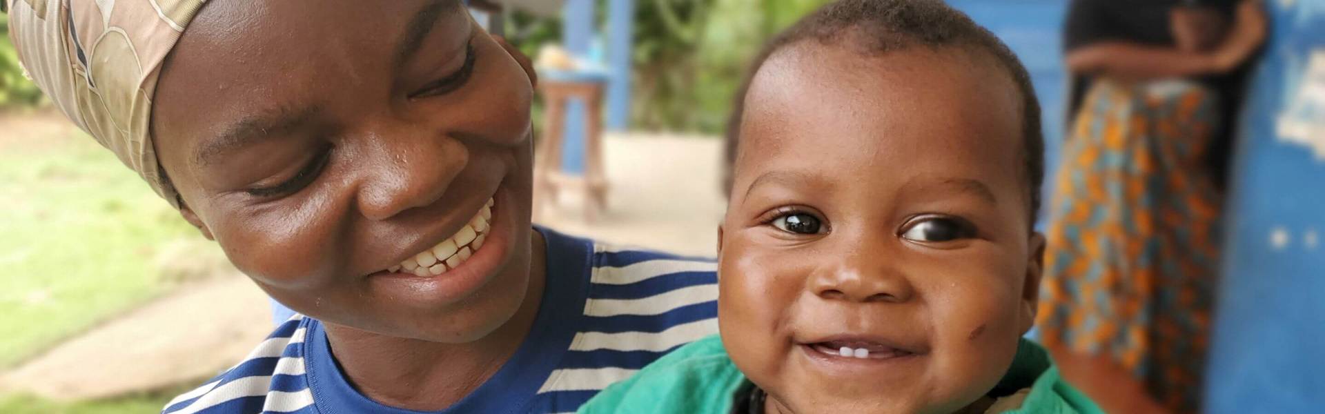 A baby smiles at the camera in Sierra Leone.