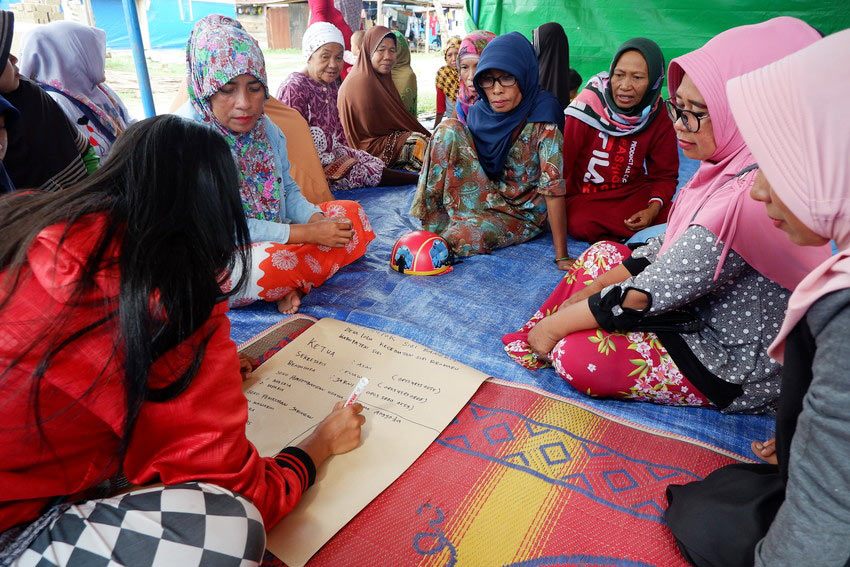 A group of women participate in a small-business training provided by ChildFund after the Indonesia earthquake.