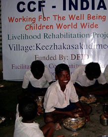 Image of men and women eating breakfast in the Tsunami Naga settlement