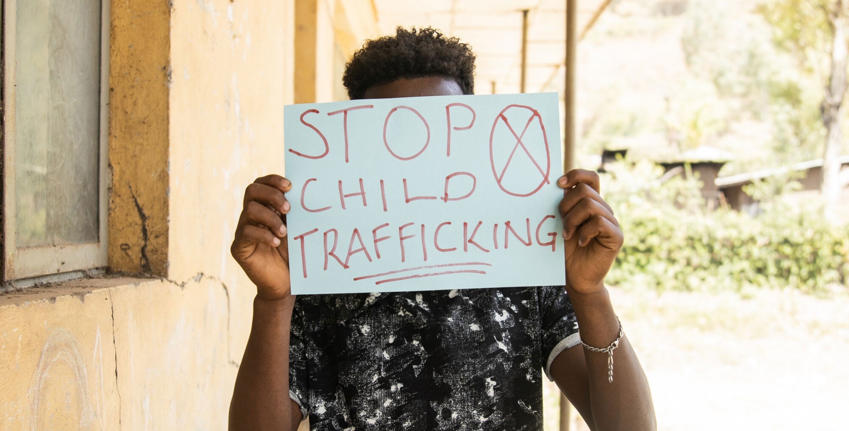 A young man in Ethiopia holds up a sign that reads 