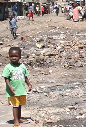 Image of a Kenyan child standing amid the rubble of recently destroyed shops
