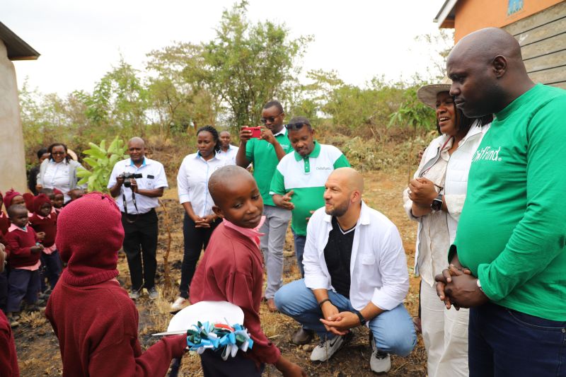 The Roberts are greeted with excitement outside two newly built preschools, generously gifted by the family.