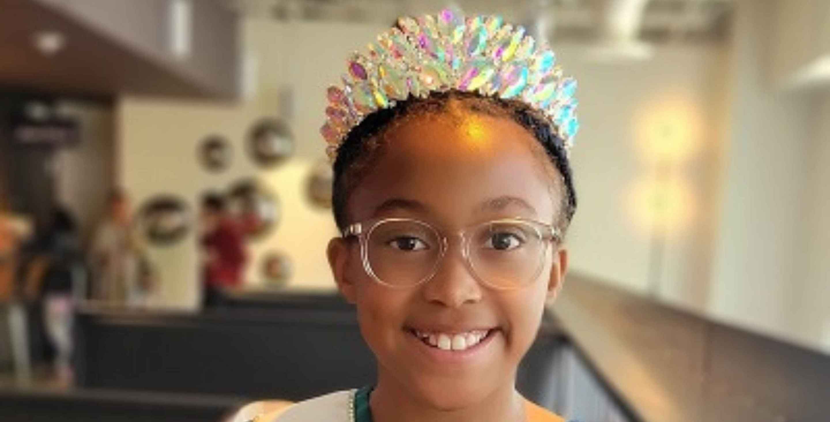 10-year-old girl wearing a crown and a Miss Virginia sash