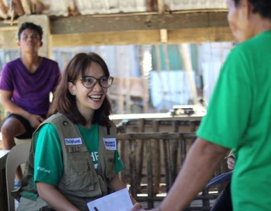 ChildFund aid worker hands out supplies