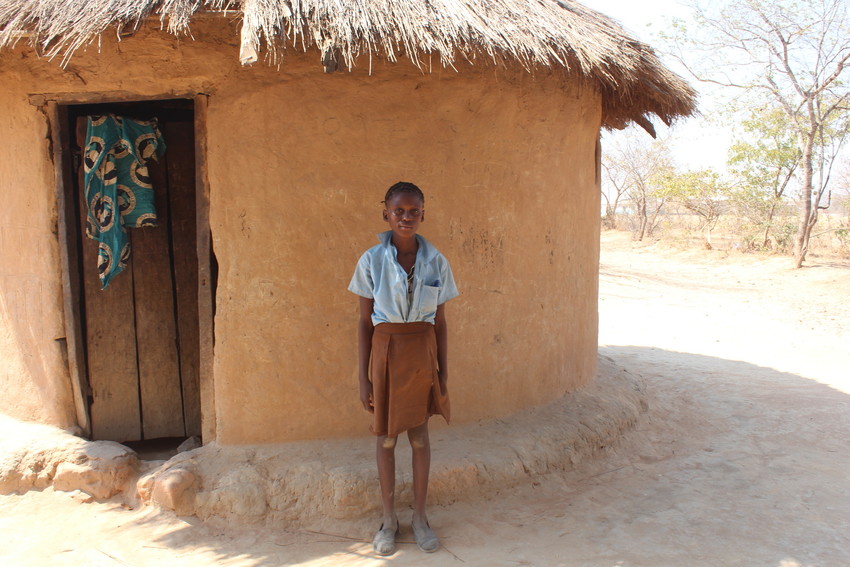 August 15, 2019, Girl sits at a desk with other students, smiling at the camera.