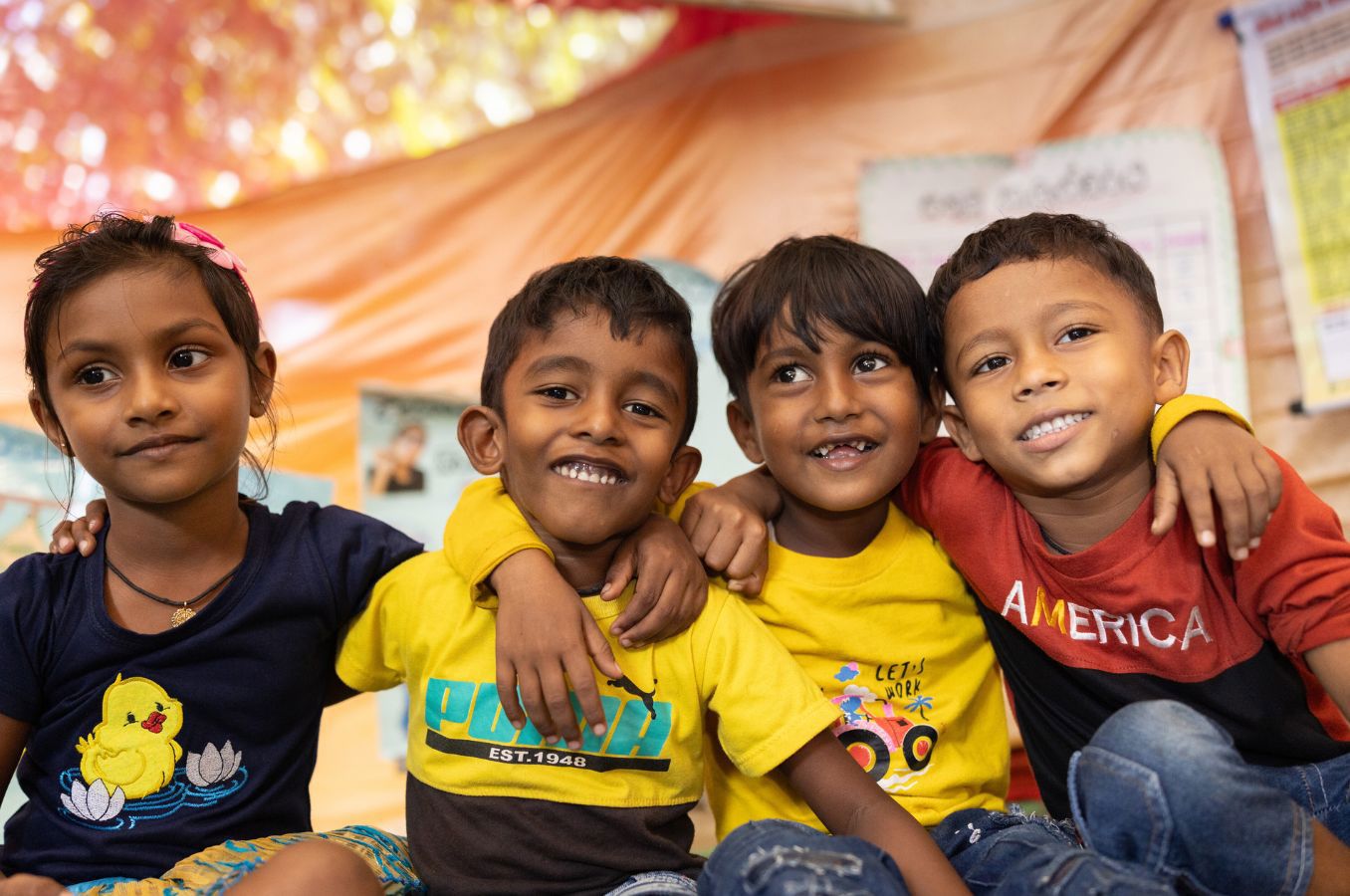 Children in Sri Lanka smile together.