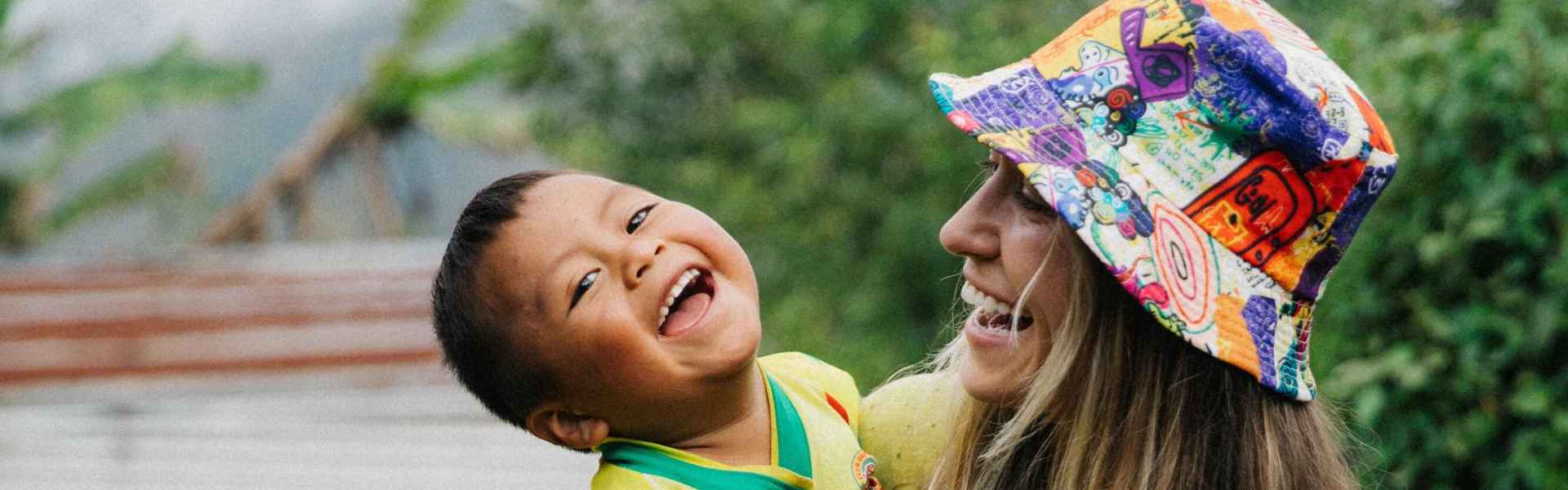 Lauren Daigle smiles while holding young sponsored child