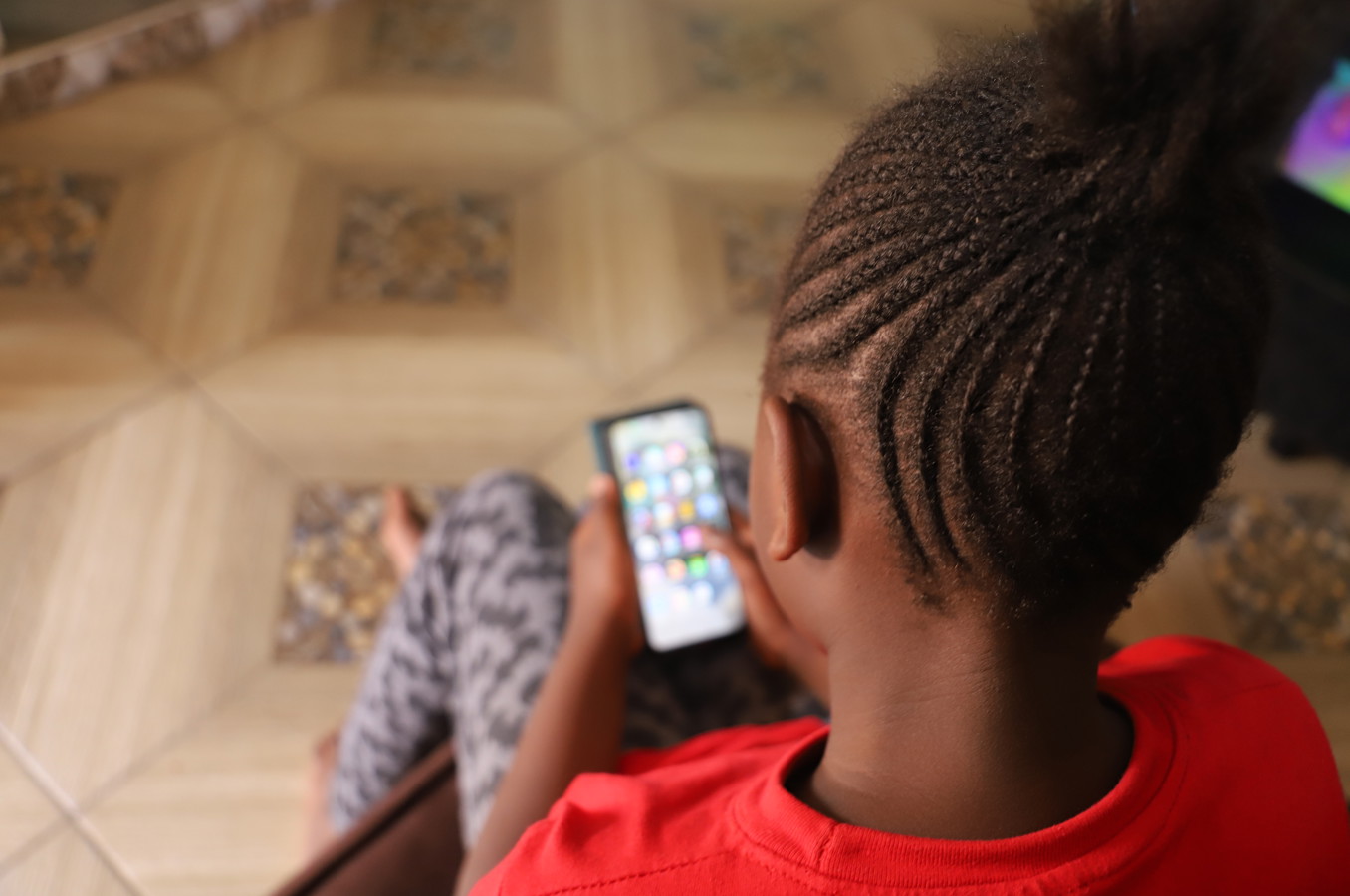 RS63980_Felicity, 9 on her mother's phone. She lives with her parents and 2 siblings in Nairobi