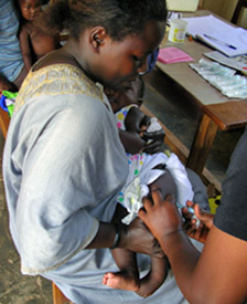 Image of an infant receiving an immunization as part of CCF-Uganda's early childhood care and development program