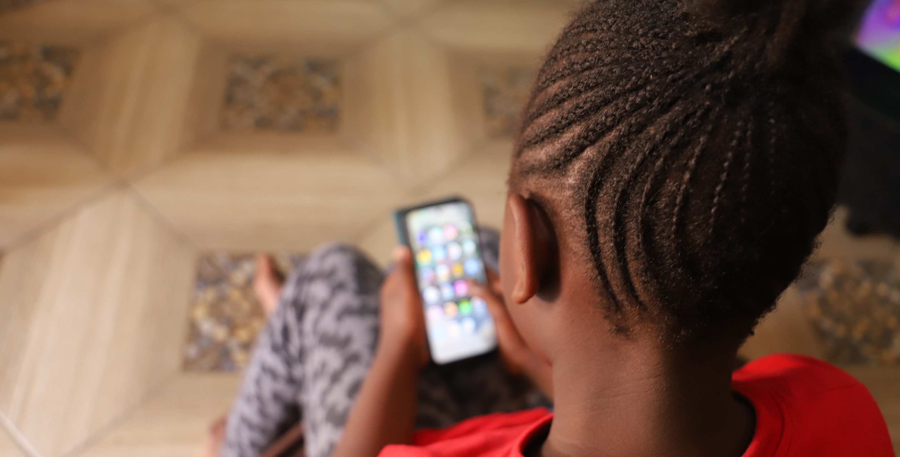 RS63980_Felicity, 9 on her mother's phone. She lives with her parents and 2 siblings in Nairobi