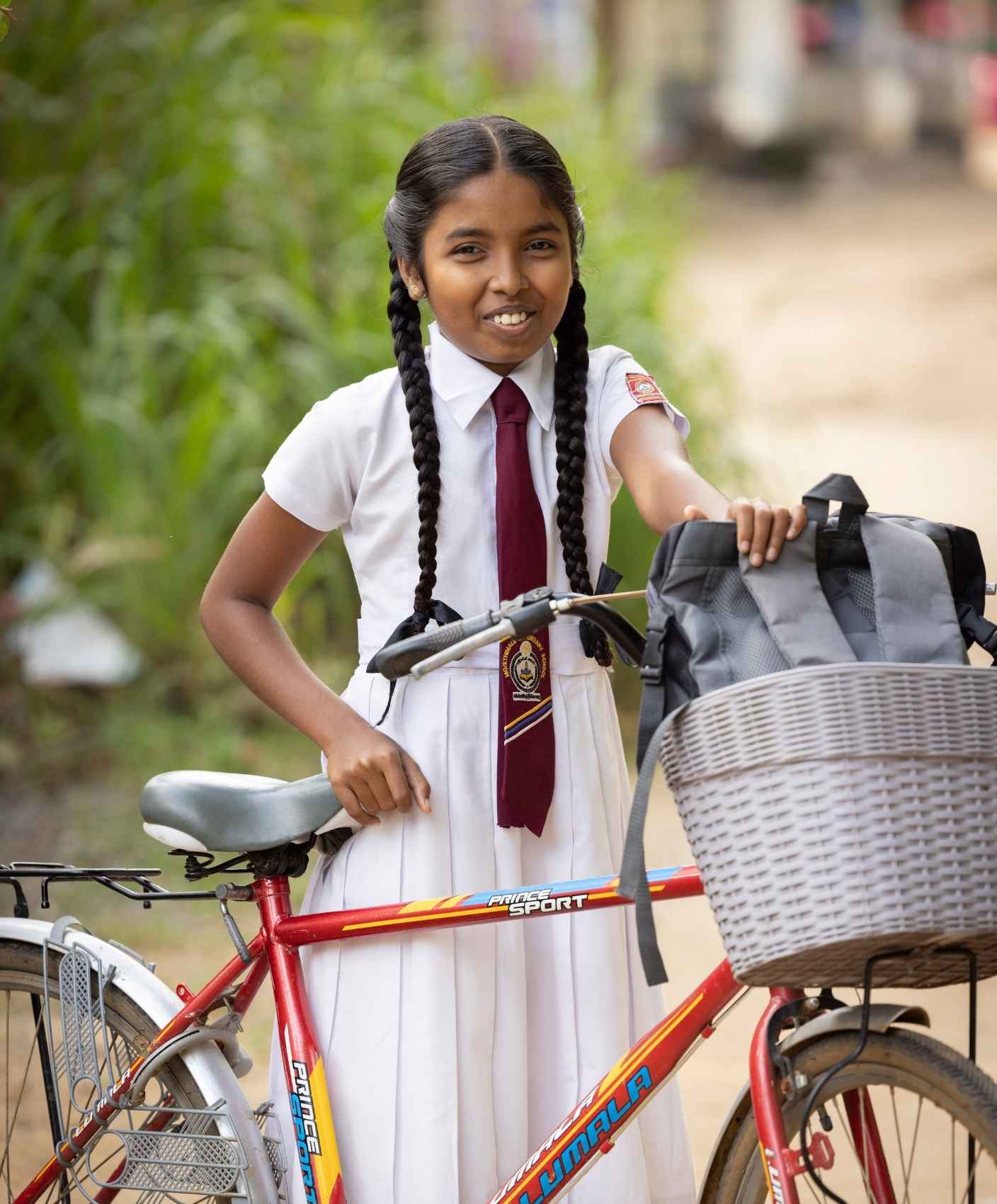 A girl rides her bike to school.