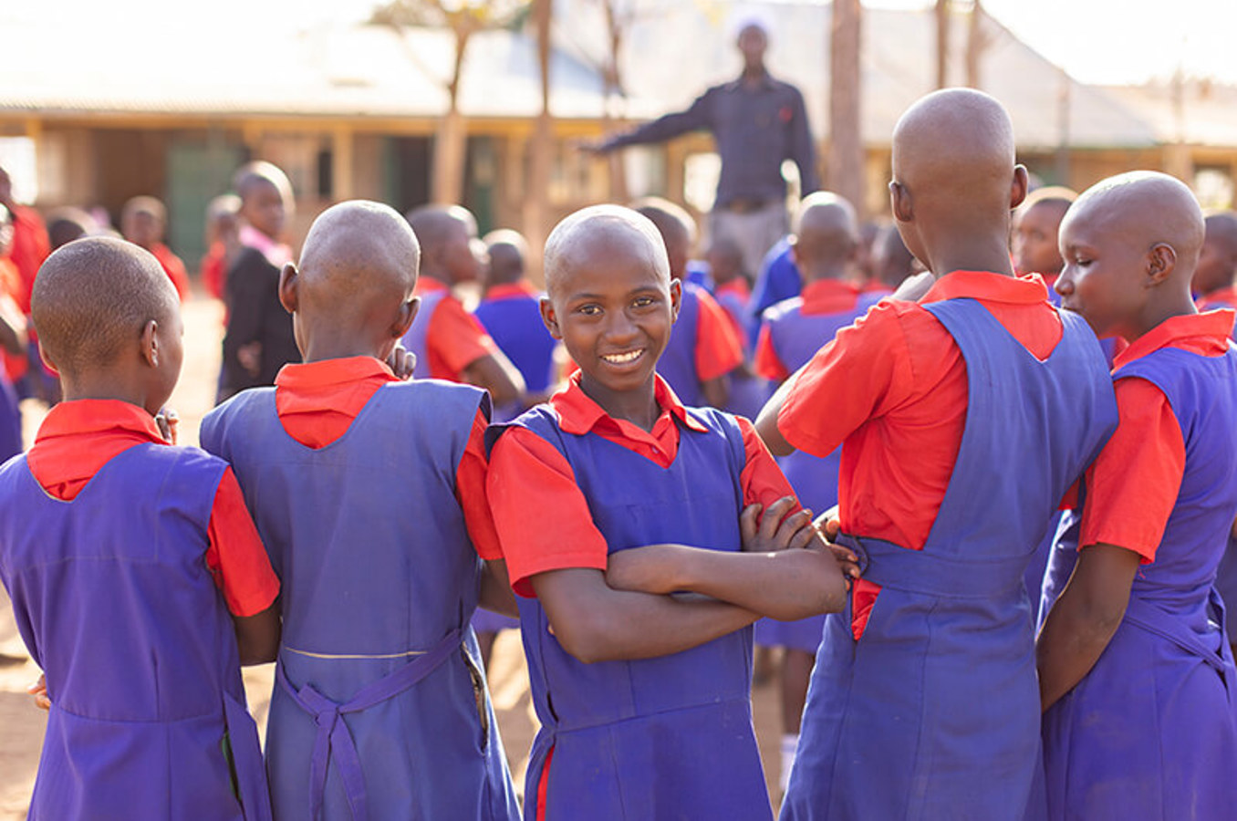 Schoolgirls in uniform gather outdoors for a children’s rights meeting in Tharaka-Nithi County, Kenya, part of ChildFund’s Jukumu Letu child protection project.