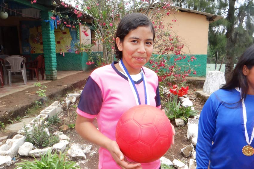 Kelin, 17, holds one of One World Play Project's unpoppable soccer balls.