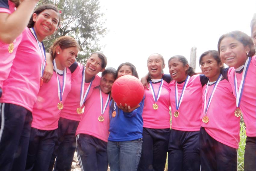 Kelin's soccer team celebrates their victory in their new jerseys.