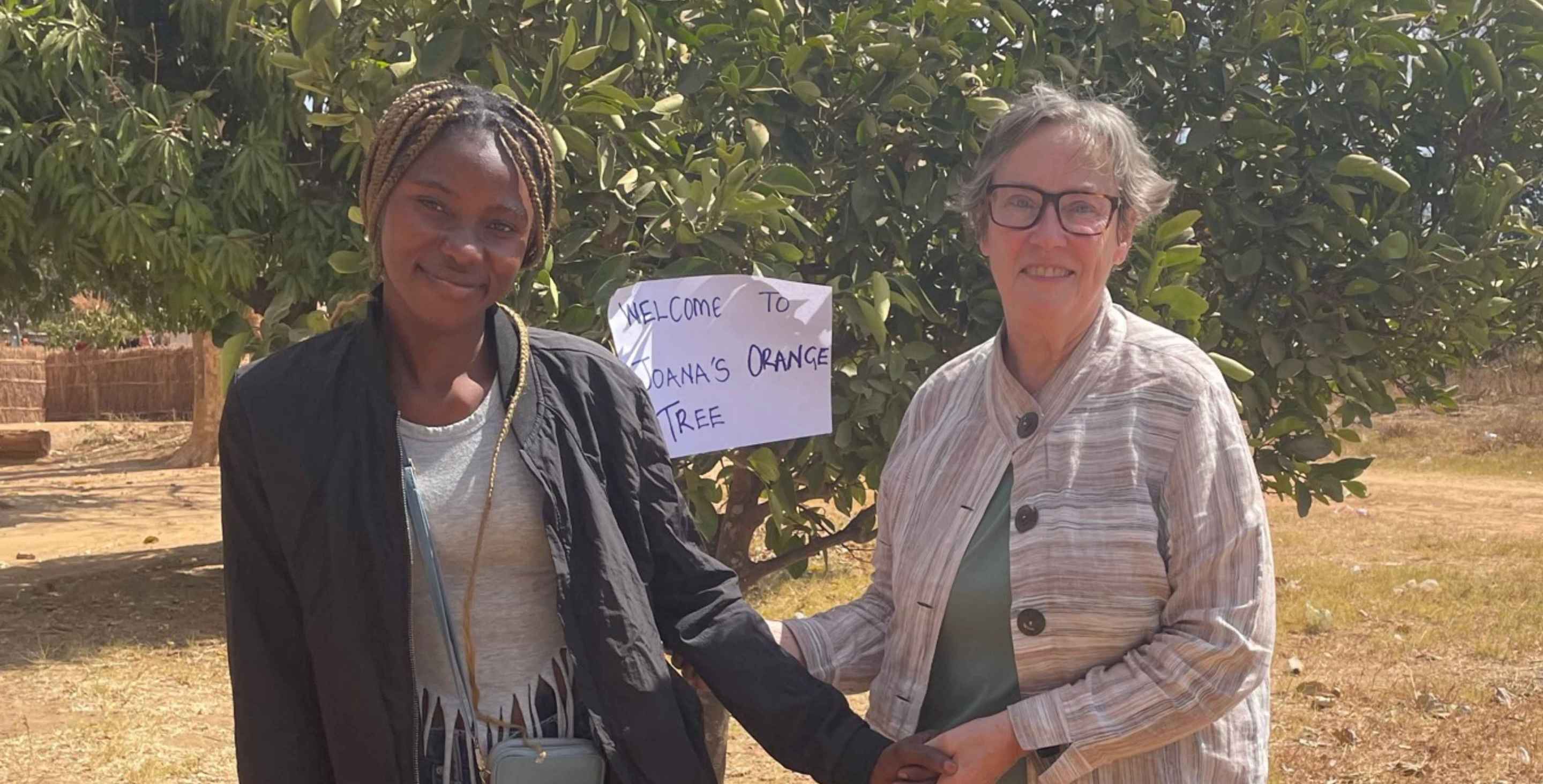a young woman standing outside with her former sponsor