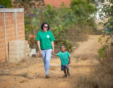 Smiling woman walking with small child