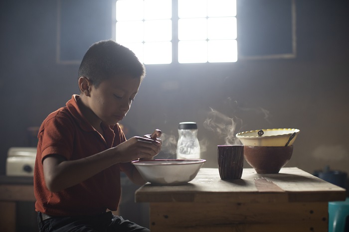 Boy eats breakfast in Guatemala.