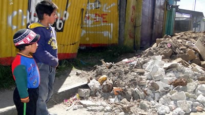 Children observe destroyed homes in Guatemala, which suffered a massive earthquake in November 2012.