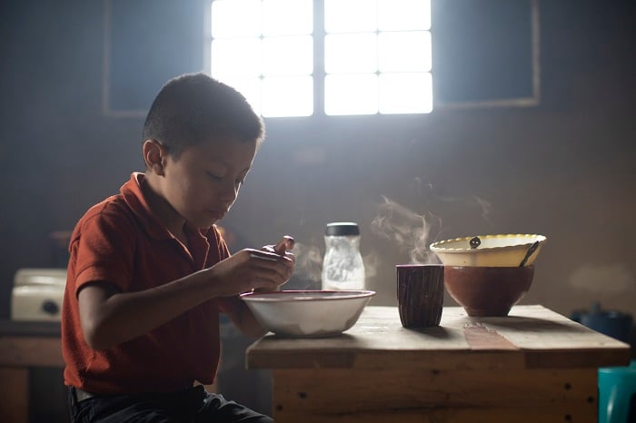 Boy eats breakfast in Guatemala.