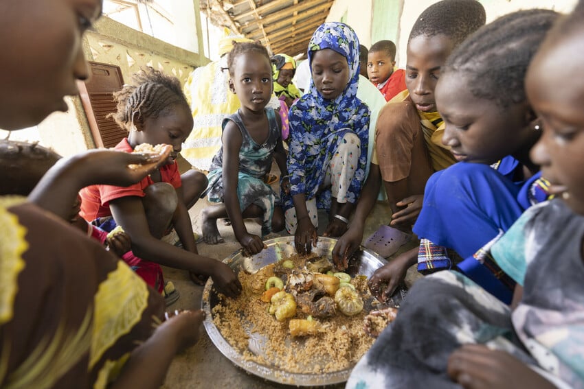 Family in The Gambia shares dinner of fish and rice.