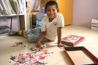 Javier Celestino, 8, loves putting this puzzle together piece by piece.
